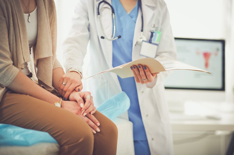 doctor holding patient's arm during medical diagnosis